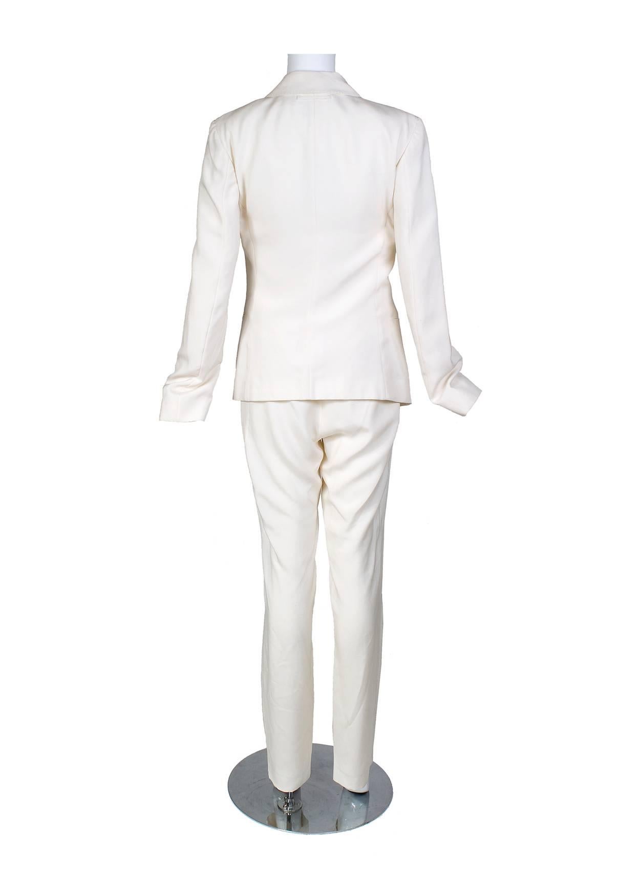 This is a cream colored silk suit by Jean Paul Gaultier c. late 1980s/early 1990s.  It features a matching bra with front buttons that can be attached to the inside of the blazer.  Pieces may also be sold separately.  

Jacket:
15.5 shoulder
24