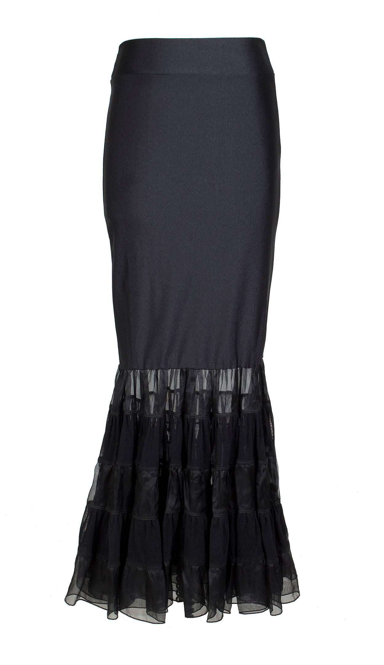 This is a tube skirt by Jean Paul Gaultier c. 2000s.  It can also be worn as a tube top dress.  The body is a black stretch material with layered and tiered ruffles at the bottom.  