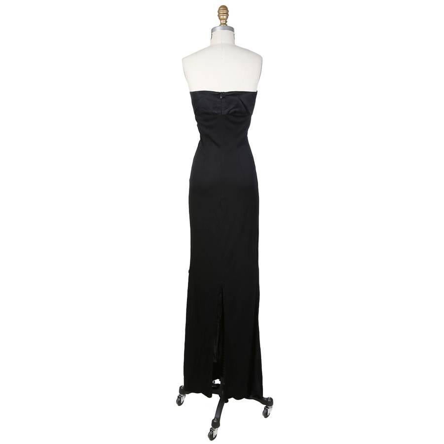 This is a strapless gown by Todd Oldham c. 1990s.  It is made of a black stretch fabric and features a satin bodice.  