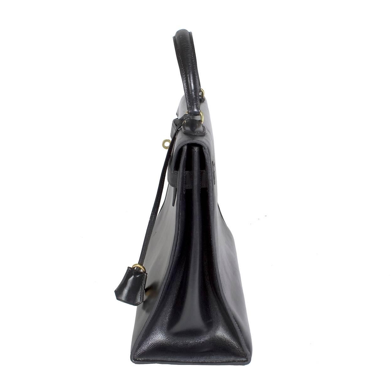 This is a black leather Kelly Bag by Hermes from 1975.  

3