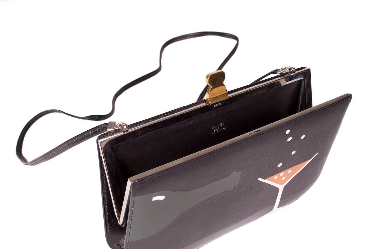 This is a leather shoulder bag by Hermes from 1988.  It features a retro cocktail design on the front and has a top clasp closure.  Can be used as a cross body bag.

Strap length is 43