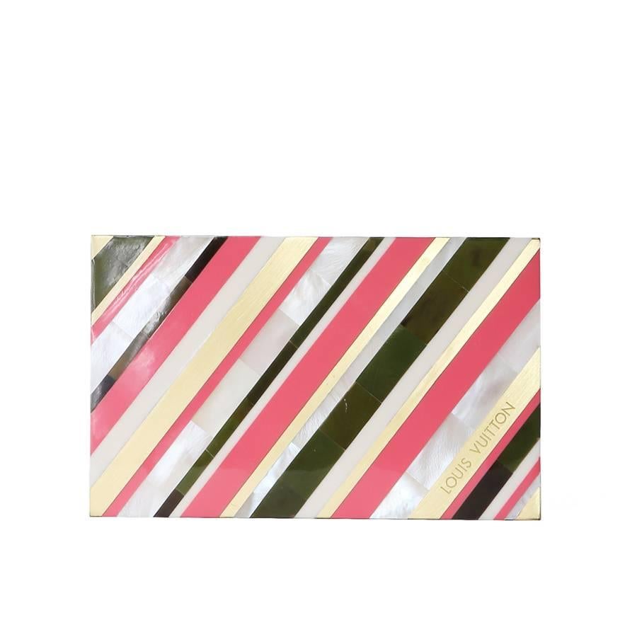 Clutch by Louis Vuitton, modern.  It features an enamel striped inlay design and has a grey leather lining. 