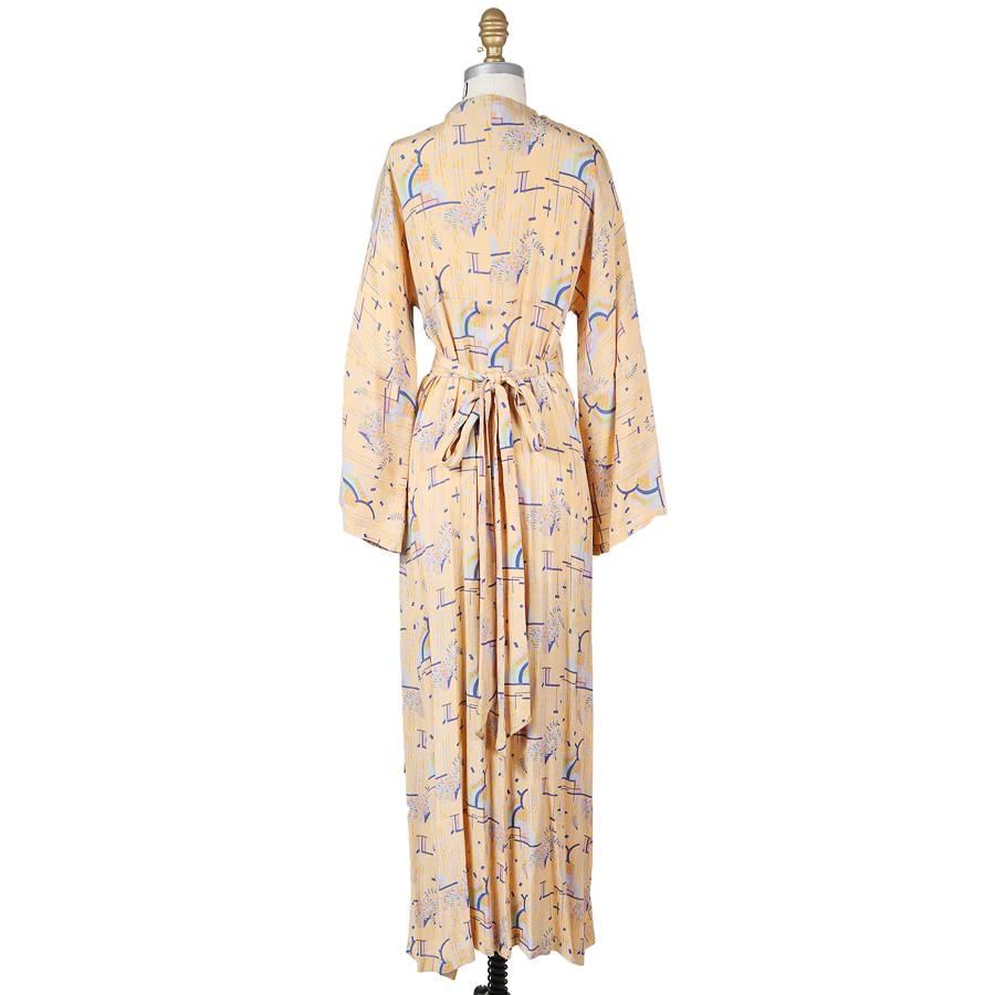 This is a caftan by Biba c. 1960s/1970s.  It features a tie to wrap around and has long bell sleeves.