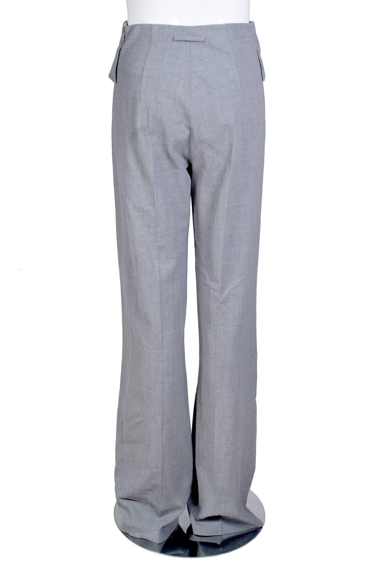 This is a pair of wool trousers by Jean Paul Gaultier c. 2000s.  It has twist lock flap closure pockets and a wide leg.  

11
