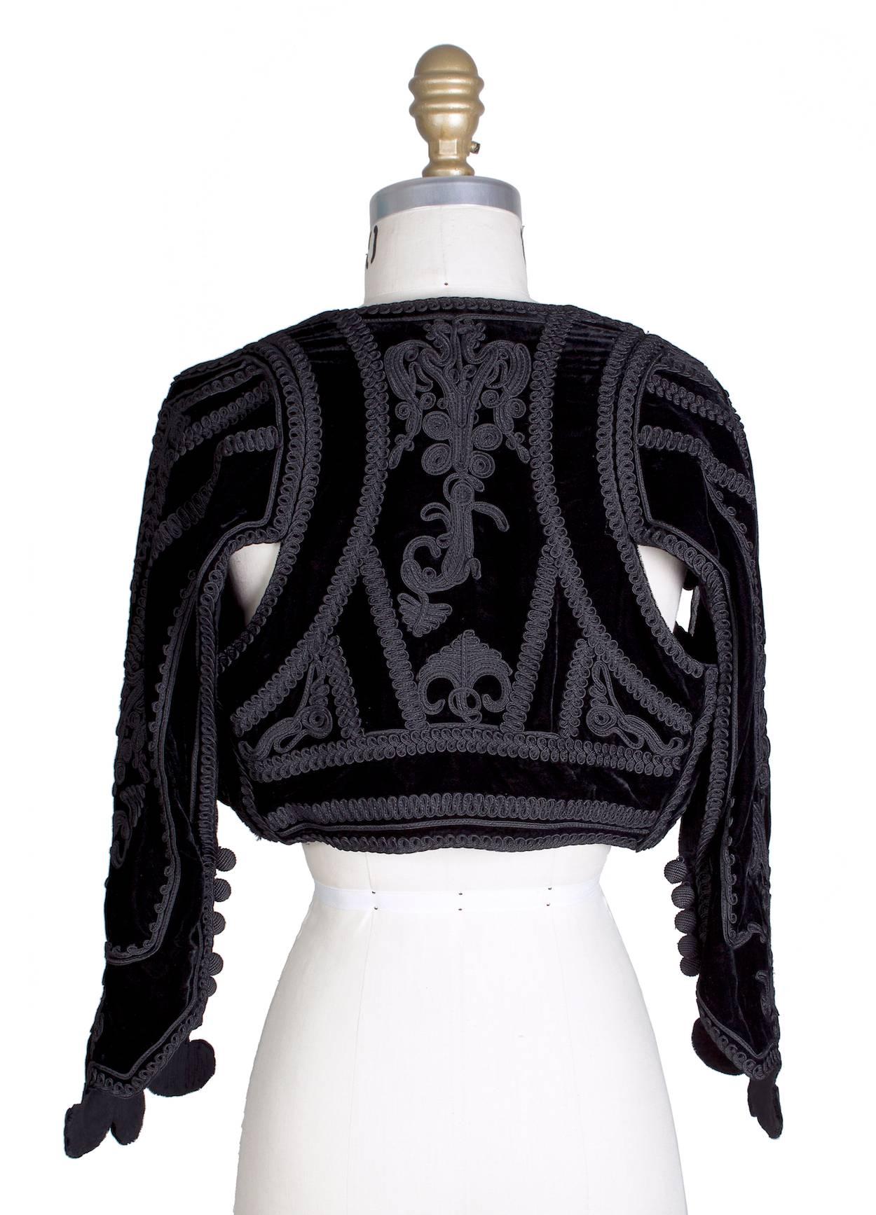 This is a black bolero jacket by Jean Paul Gaultier c. 1990s.  It features thick embroidery details all around.  

13