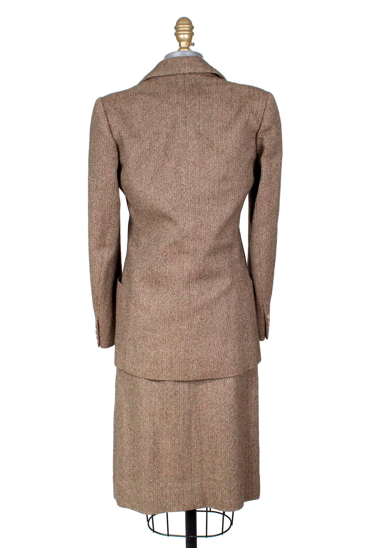 This is a 3 piece tweed skirt suit by the label Jean Patou circa 1950s.  It features a two button single breast closure on the jacket, and a 5 button single breast closure on the vest.  The skirt has a back zipper with top snaps and hook and eye