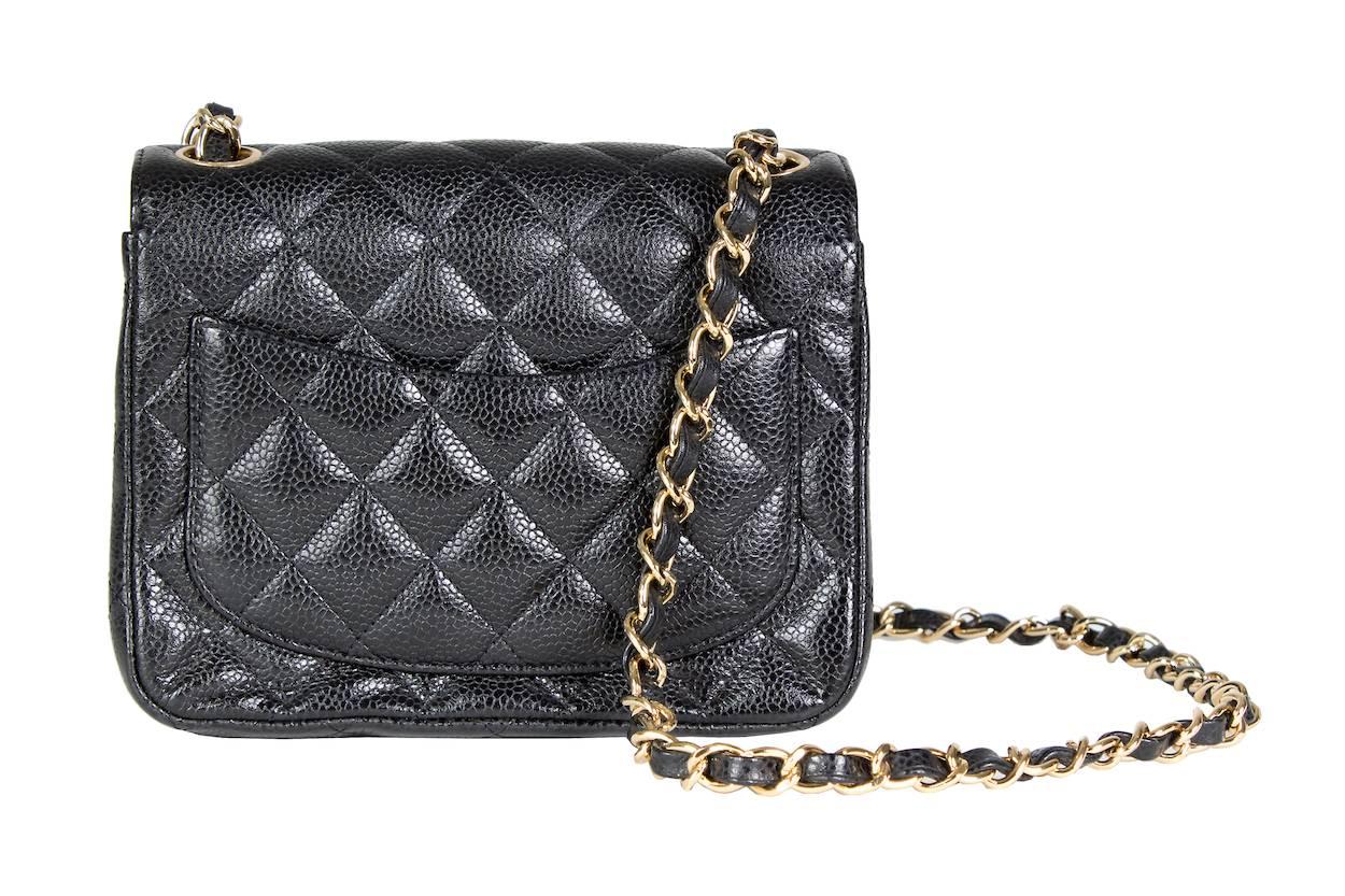 This is a mini flap bag by Chanel from 2009/2010.  It features black caviar leather and a twist lock closure.  The interior is black leather and the bag has gold hardware.

19" strap drop