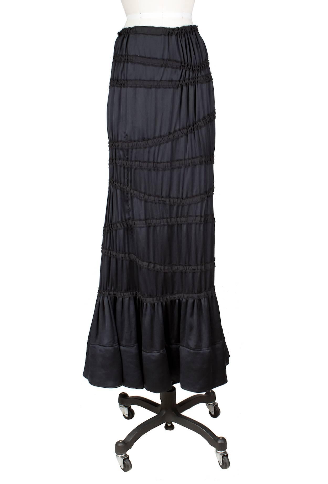 This is a modern black peasant skirt by Tom Ford for YSL from the Fall 2001.  It features ruched piping tiers and the closure is an invisible zipper down the side with a top hook and eye closure.  