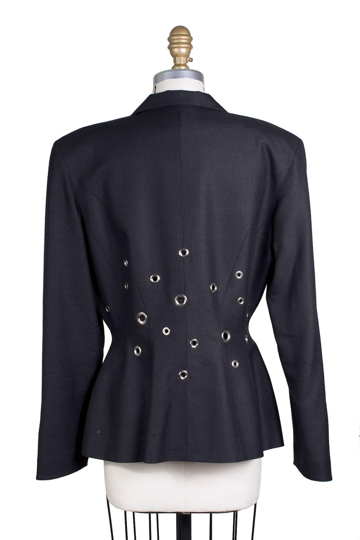 This is a blazer by Thierry Mugler c. 1990s.  It features a large lapel and grommets around the waist area.  It has two snap closures in front.

17