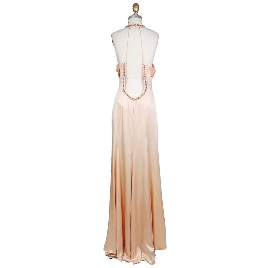 This is a peach silk gown from Versace c. 1990s.  It features crystal jewel embellished neckline, open back, and key hole in front.  