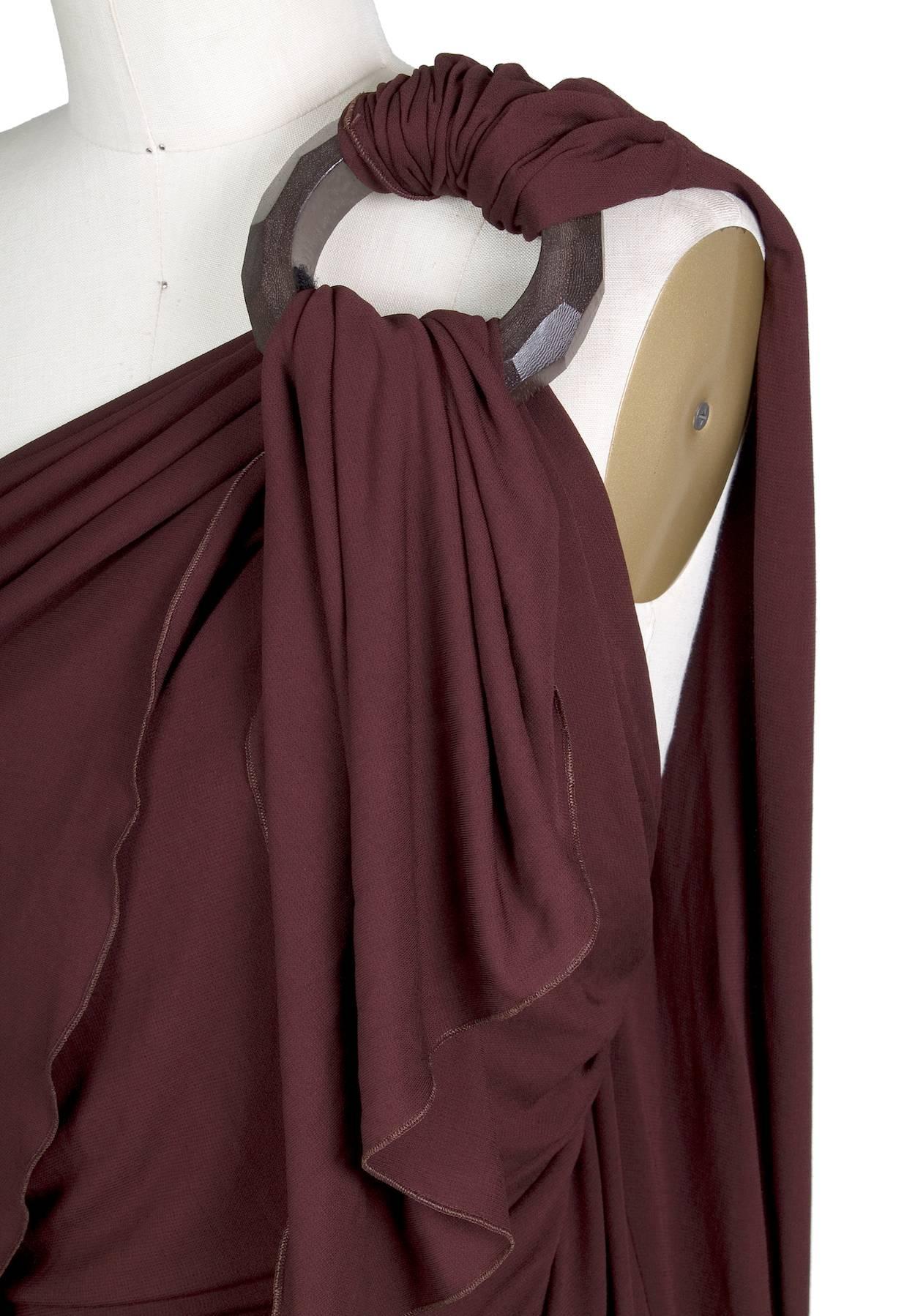 This is a dress by Jean Paul Gaultier c. 1990s.  It uses a wooden ring to loop and drape the dress.  

Please inquire for measurements. Estimating the size is a US 6.