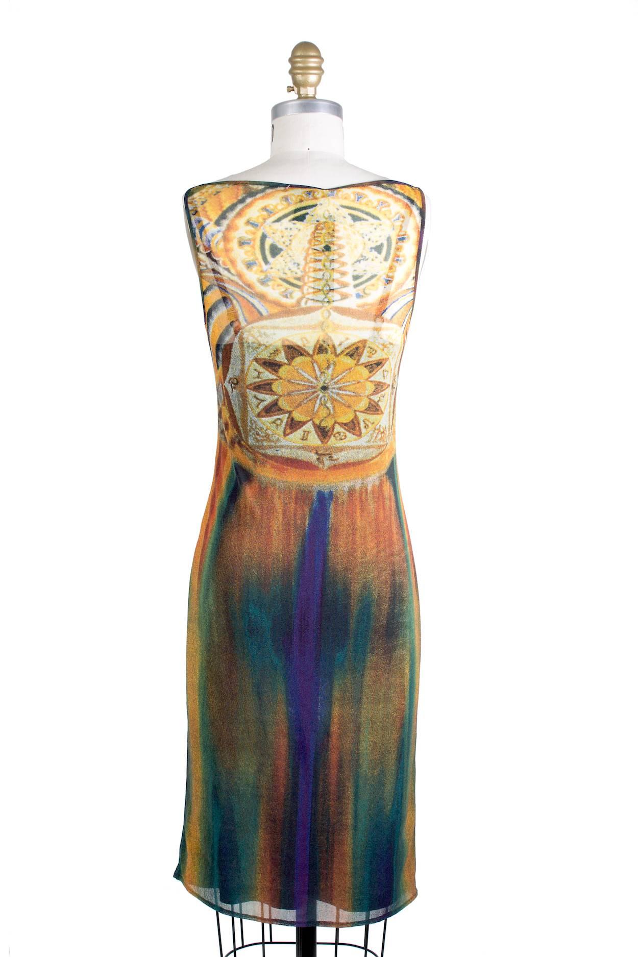 This is a dress by Vivienne Tam c. 1990s.  It features a multicolor printed sheer mesh.  The dress includes a purple slip.  This dress has stretch to it.