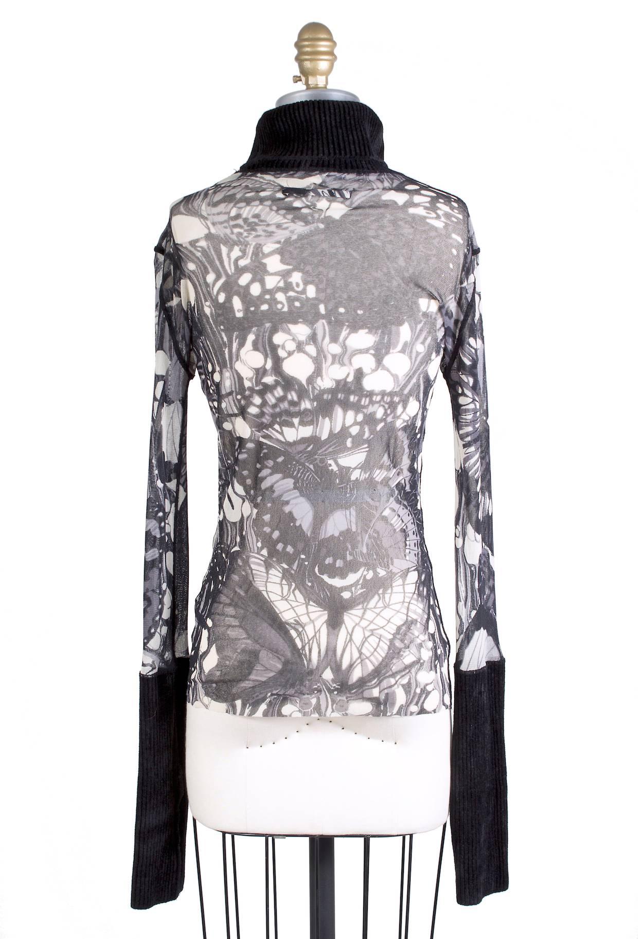 This is a turtleneck top by Jean Paul Gaultier circa 2000s.  It features and black and white butterfly print mesh with black knit collar and cuffs.  

17