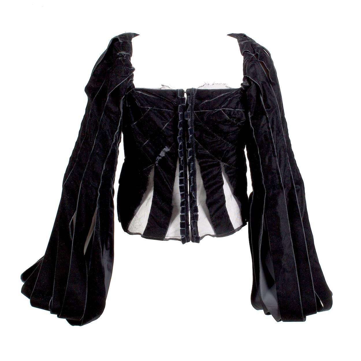 This is a top by Tom Ford for YSL rive gauche.  It features a structured corset body with large velvet ribbons creating a bishop style sleeve.  There is black mesh accents in the corset.  

33