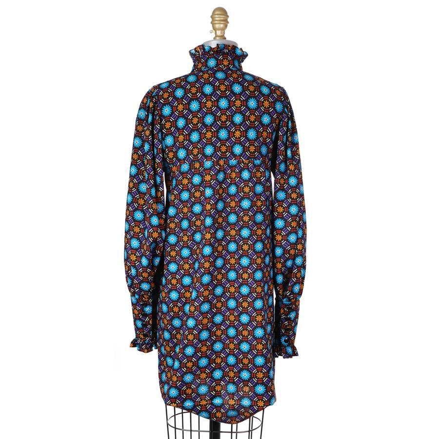 This is a high waisted shirt dress by Saint Laurent Rive Gauche c. 1970s.  It features a geometric print, high collar with a ruffle, and ing cuffs with a ruffle.  Front button closure.  

13