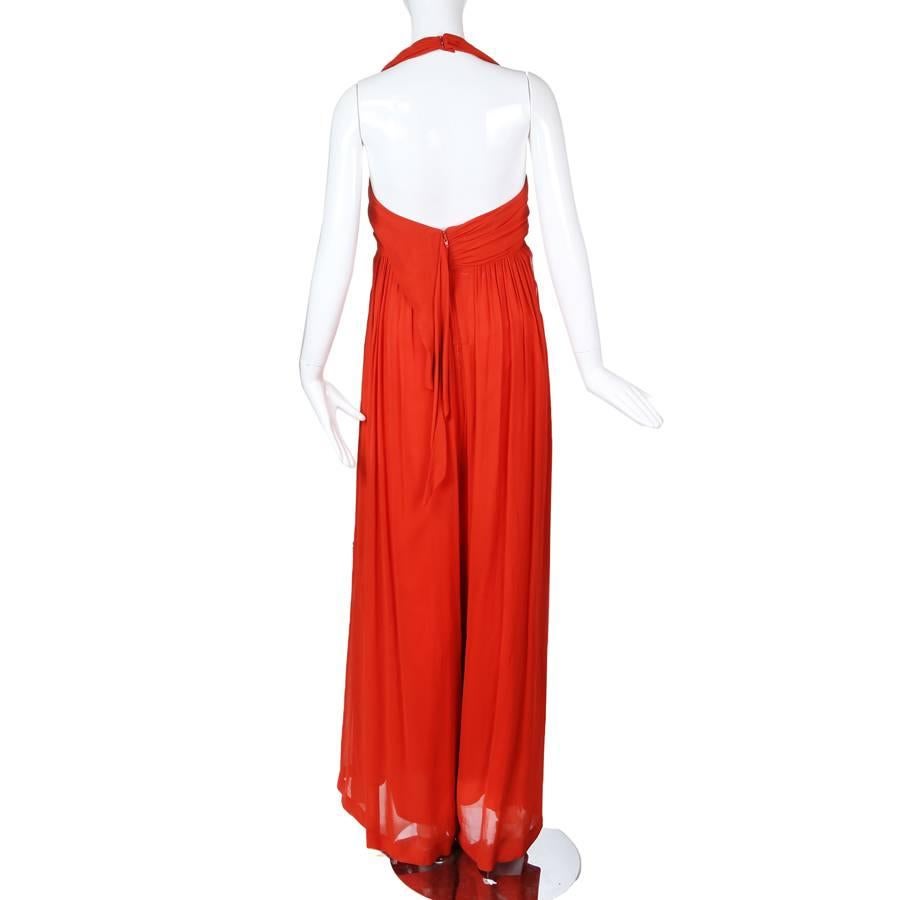 This is a jumpsuit by Christian Lacroix c. 1990s.  It features a halter neckline and the pants have drapes attached to them on the side to give the illusion of a dress.  Empire waist fit.  