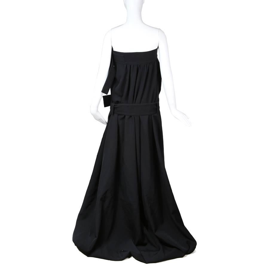 This is a contemporary Yohji Yamamoto dress.  It is made from black wool and features two grommeted belts around the bust and the waist.  The cotton lining of the dress also features a drawstring closure in the bust for an additional fit.  Max bust