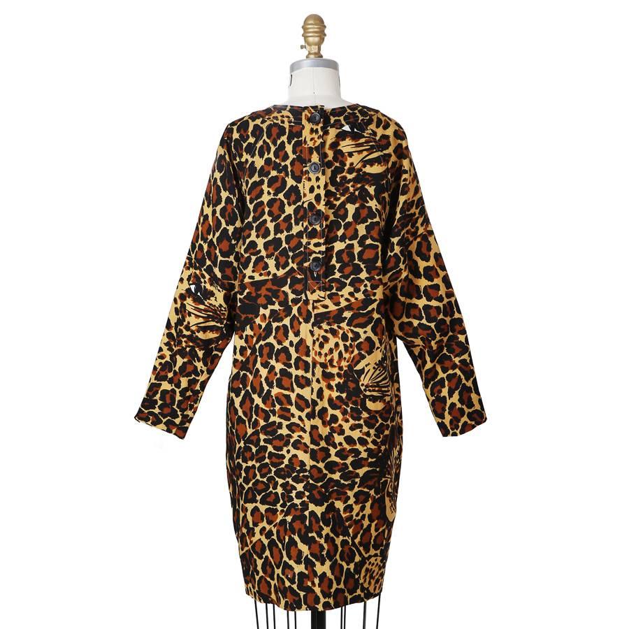 This is a lightweight poly/wool dress by Saint Laurent Rive Gauche.  It features a leopard print with hidden leopard faces.  The dress has two waist pockets, tapered sleeves, and a back button closure.