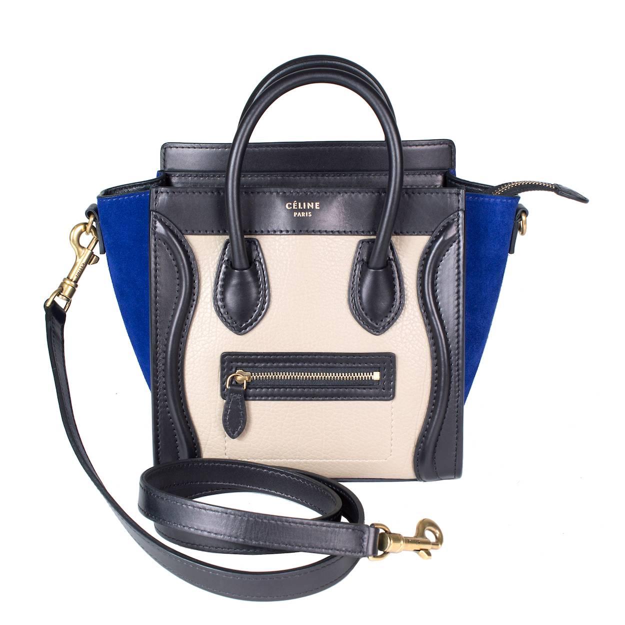 This is a modern mini tote from Celine.  It features black and taupe leather with royal blue suede.  It comes with a detachable 43