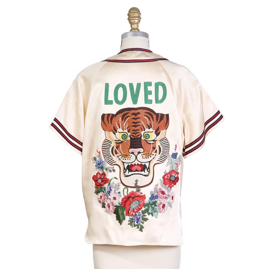 This is a shirt from Gucci from the S/S 2017 collection.  It features sports jersey design details and has a beaded and embroidered lion and floral design on both the front and back.  Raglan cut sleeve and a relaxed fit.  Rare and limited because of