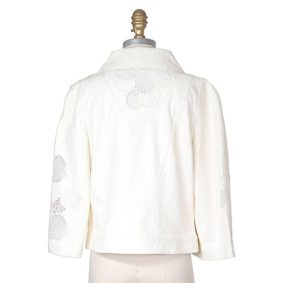 This is a jacket by Chanel.  It features transparent mesh shells outlined with embroidery.  It has a cropped fit and 3/4 sleeves.  Lambskin outer and lined in silk/cotton.