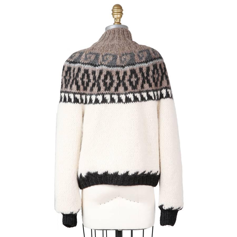 This is sweater by Jean Paul Gaultier for Hermes.  It features a zip up front closure and has a raglan sleeve.  The outer is 100% sure alpaca and the inside is lined in a printed silk.  