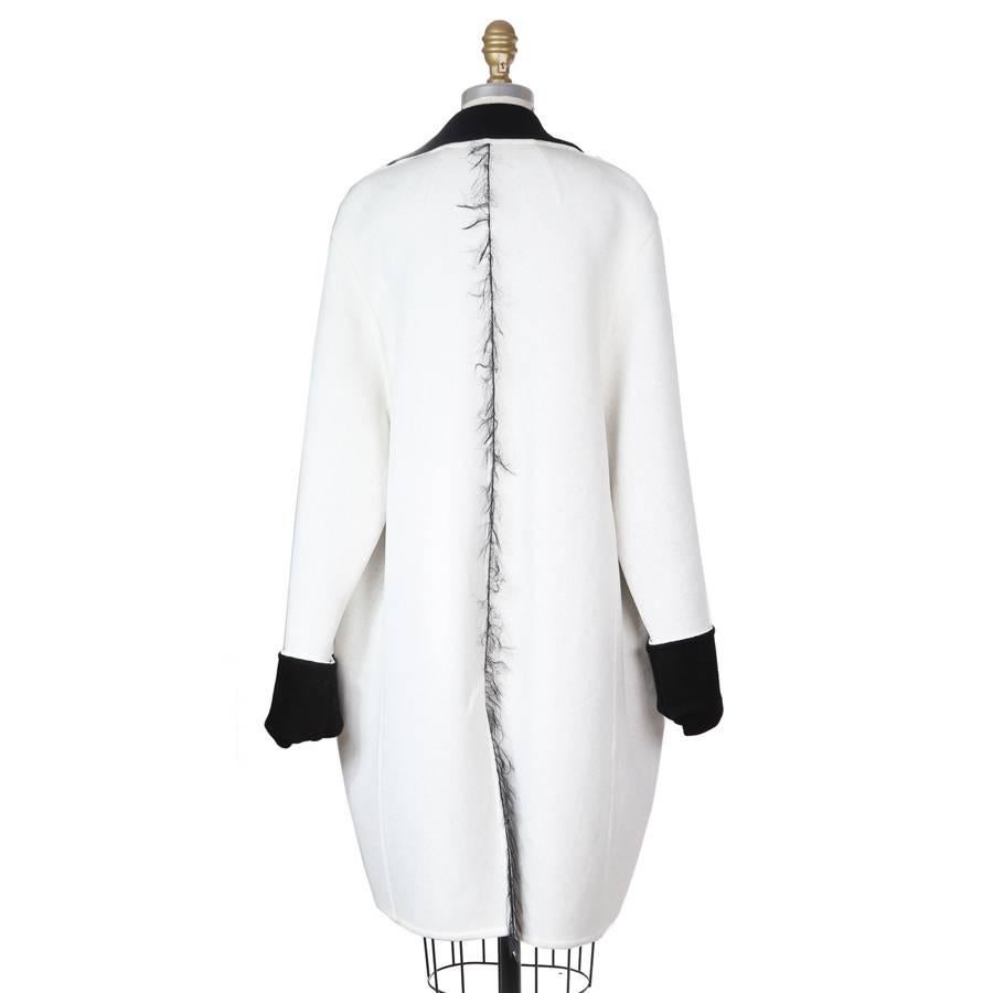 This is a coat by Celine.  It has a single breast closure, and the outside is a heavy stretch knit fabric and the inside is lined in microfleece.

18