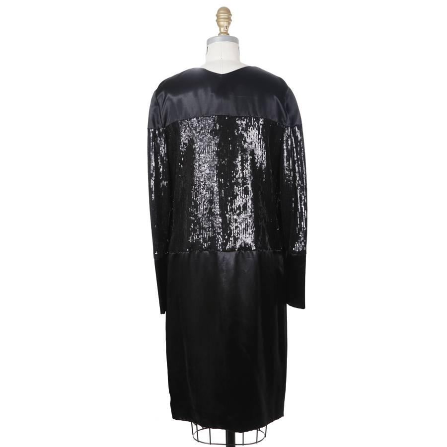This is a dress from Chanel.  Features a sequin blocked design.  It has a satin rayon outer, silk lined.

16