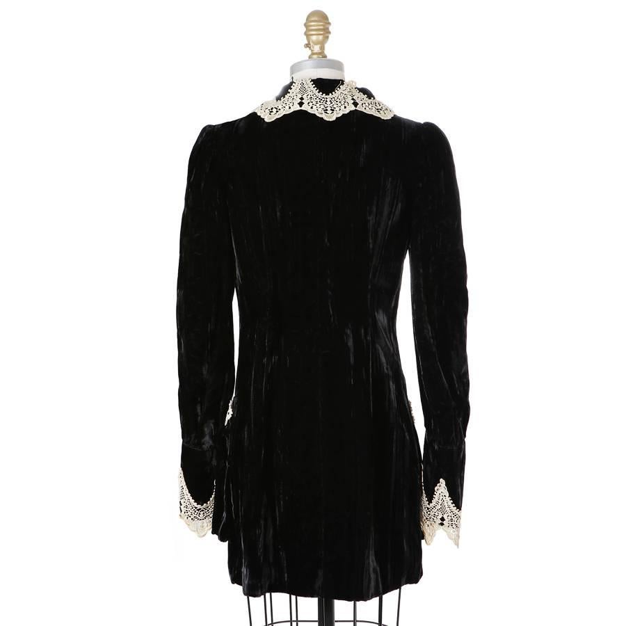 This is a jacket from Anna Sui c. 1990s.  It's made from black velvet and features off white lace collar, cuff, and pocket accents.  Button closure down the front.  

15
