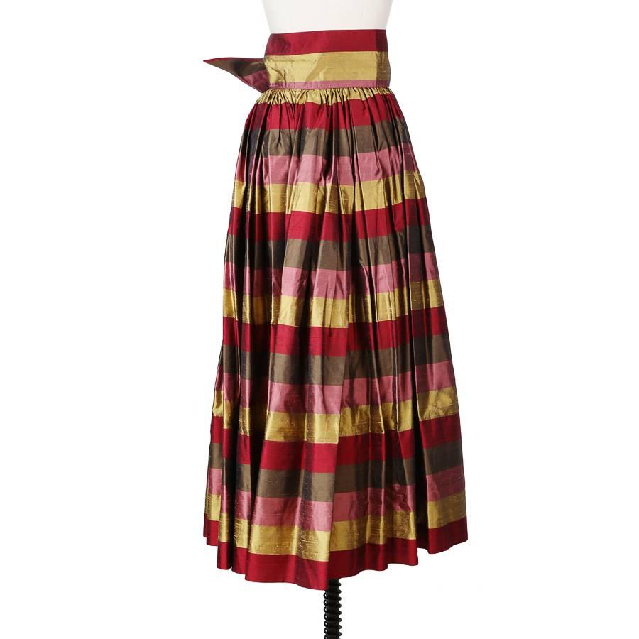 This is a striped taffeta skirt by Todd Oldham from the 1990s.  Full pleated skirt with hook closure on the waist.  