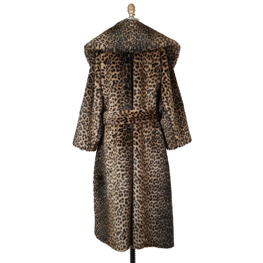 This is a coat by Azzedine Alaia circa 1990s.  It is faux leopard and includes a matching belt and two waist pockets, no closures.  It also features an oversized collar/lapel.  Lined in satin.