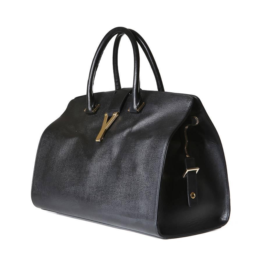 Cabas leather handbag by YSL.  It features a gold Y magnetic snap closure and the inside is lined in black canvas and features an inner zip pocket.  

5.5