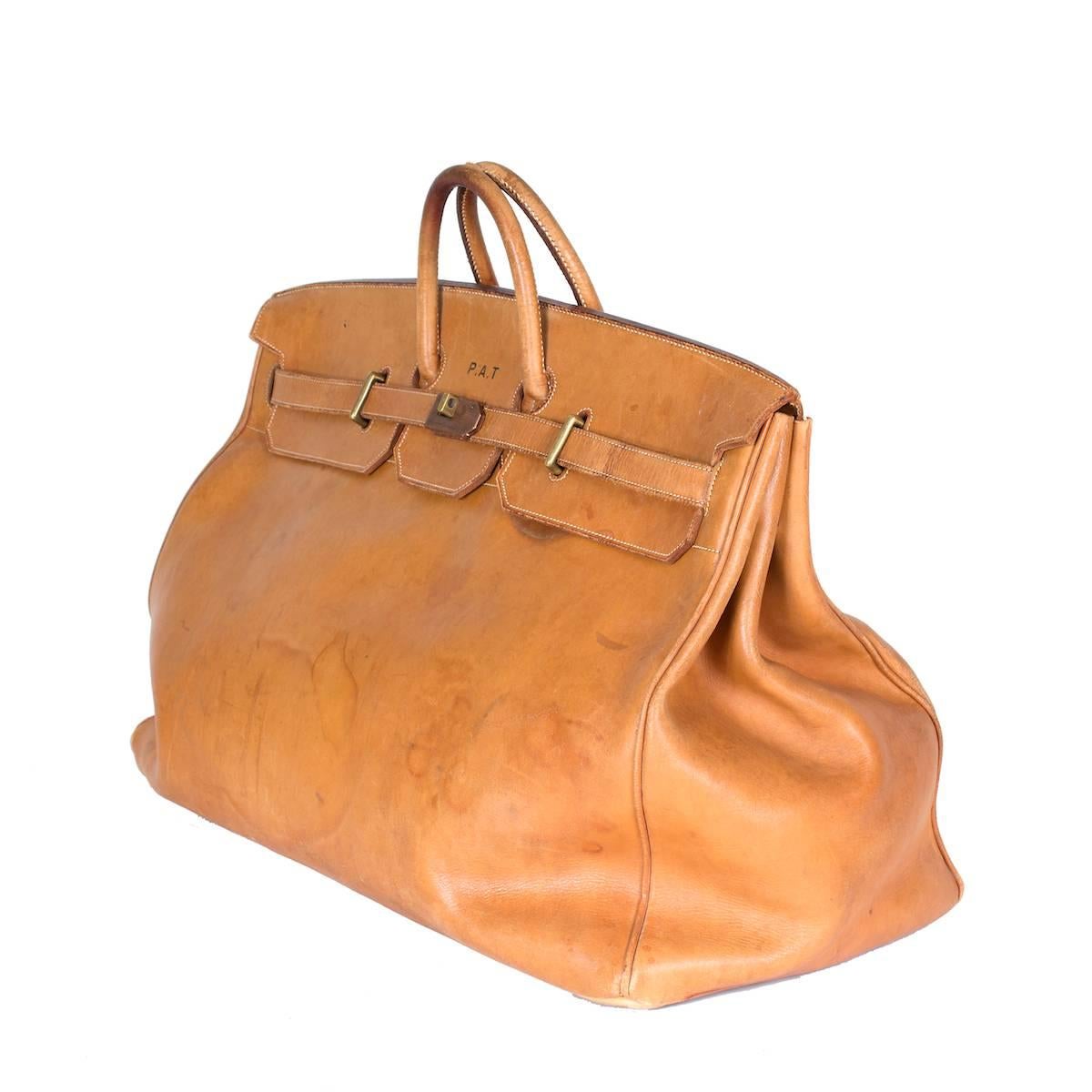 This is a vintage luggage piece from Hermes pre 1971.  It is made with a smooth natural color tan leather.

24