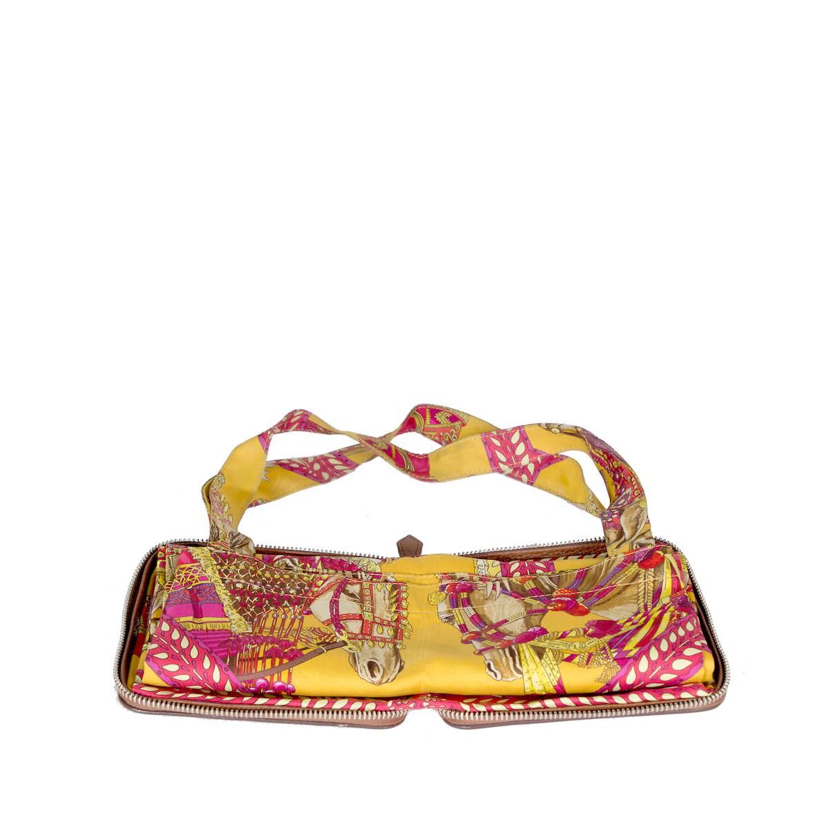 Printed silk tote by Hermes.  The bag can be folded into it's attached brown leather wallet case that zips closed.  

Leather case dimensions:  5.5