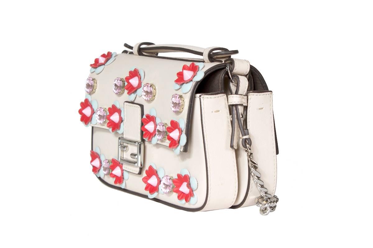 This is a leather shoulder bag from Fendi. It features jewels and three dimensional leather flowers on the front.  Flap closure on both sides.

22.5