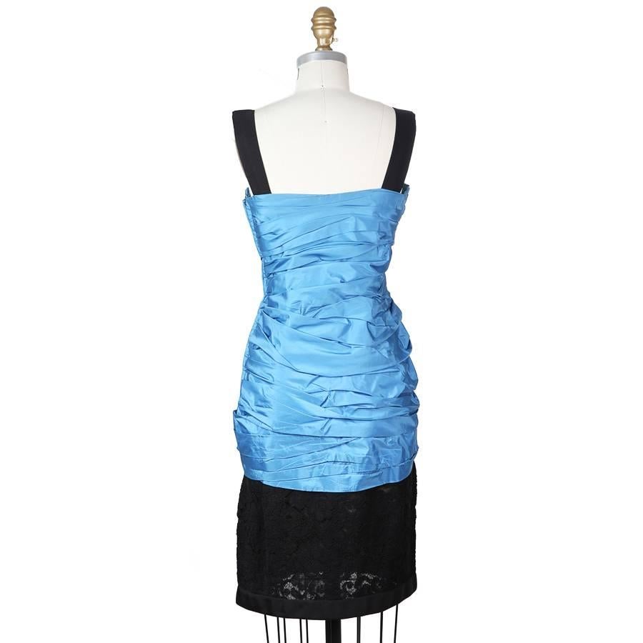 Vintage haute couture dress by Yves Saint Laurent.  It has layered blue taffeta with a black lace skirt.  Wide shoulder straps and a sweetheart neckline.

Haute couture #58447