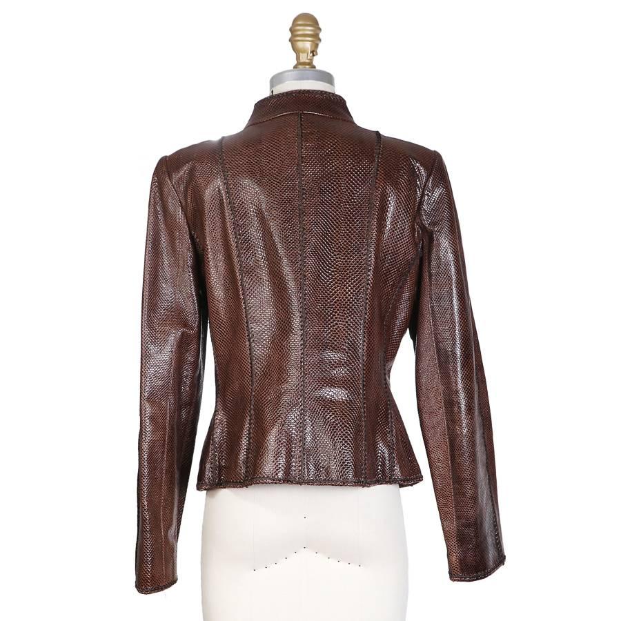 Jacket by Oscar De La Renta.  Made from a cognac colored lizard skin. Features rounded collar and hook and eye closures. 

15