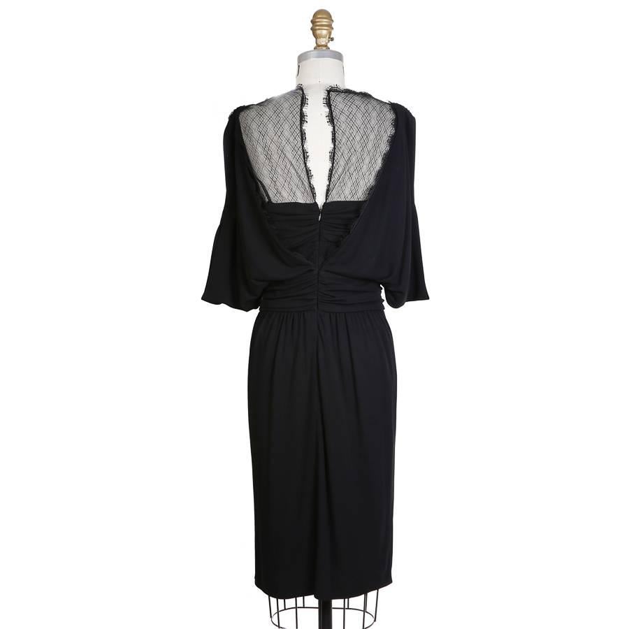 This is a dress from Chanel.  It has a mesh overlay on the neckline and a ring medallion on the bust.  

Retailed for $6580