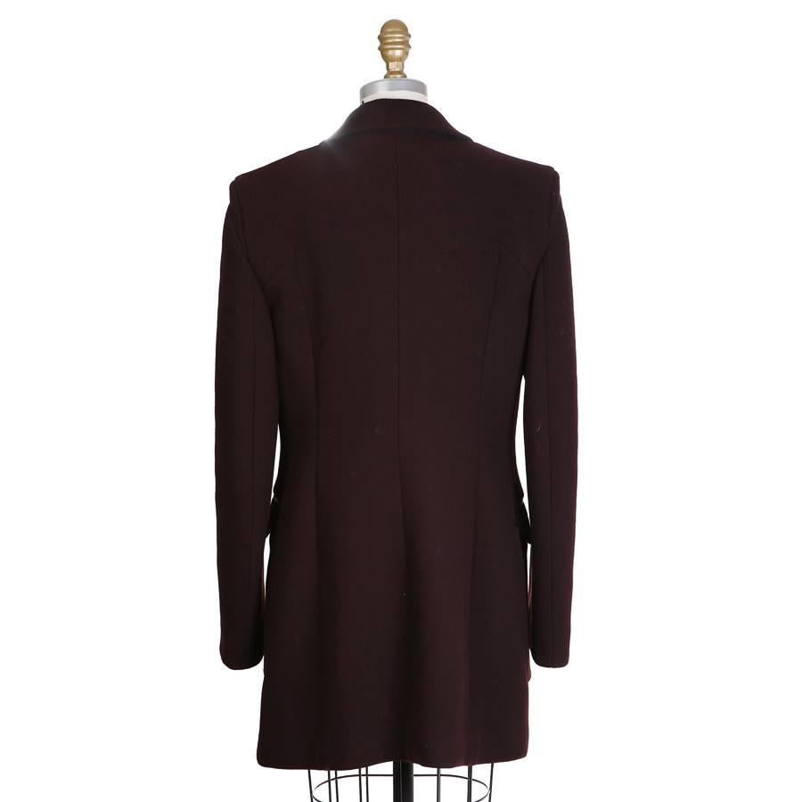 This is a peacoat by Prada.  It is made with a dark burgundy wool outer and lined in a twill.  It features a double breast closure.

18
