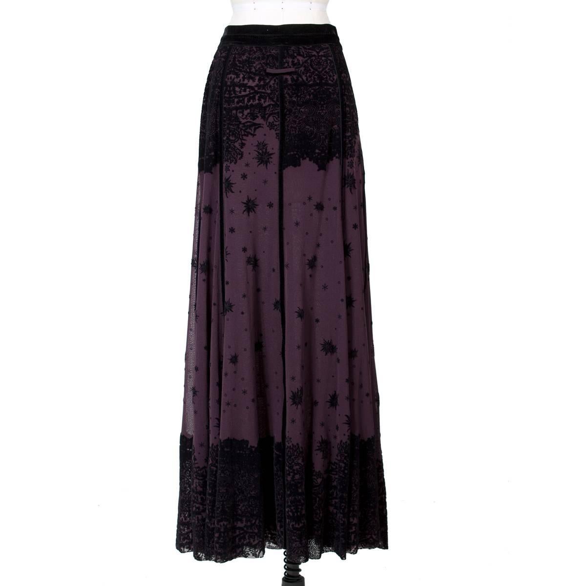 This is a skirt by Jean Paul Gaultier Soleil c. 2000s.  It is made from purple mesh with black velvet details.  It has an opaque lining for coverage and some stretch.  