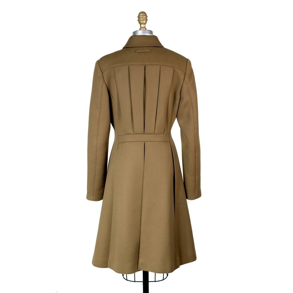 This is a trench coat by Jean Paul Gaultier.  It is made from a olive green brown wool cashmere and features slit pockets in front lined in black leather.  Snap buttons closure in front and lined in satin.

17