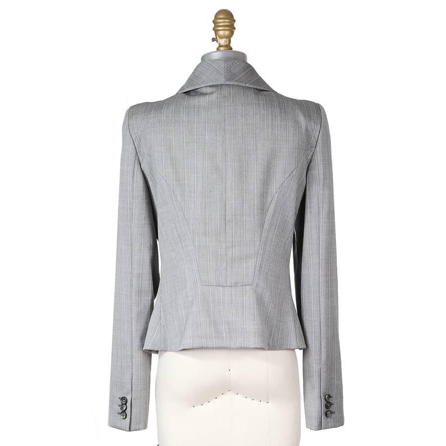 Grey wool blazer by Alexander McQueen.  It features large button down lapels and structured shoulders.   Wool with a satin lining.

15
