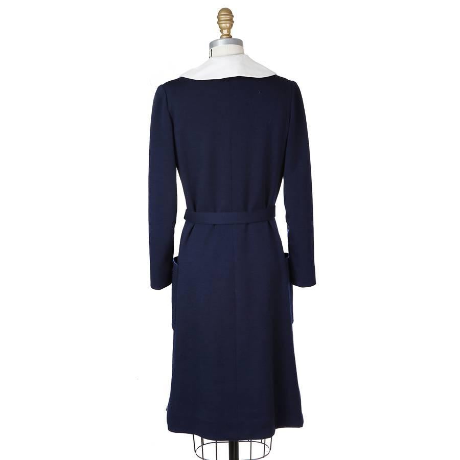 Vintage wool sailor dress by Norman Norell.  It features double breast buttons with anchor sailor patch detail and includes a belt.

14.75
