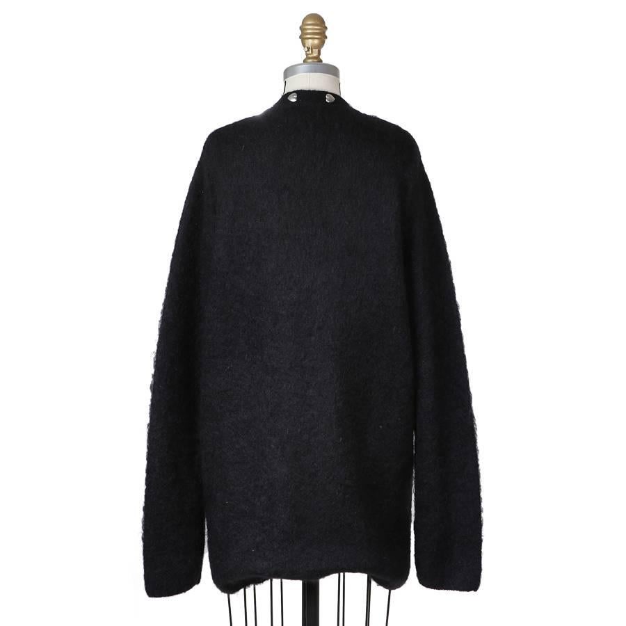 This is a mohair cardigan by Saint Laurent that features silver metal hearts around collar and down front.

16