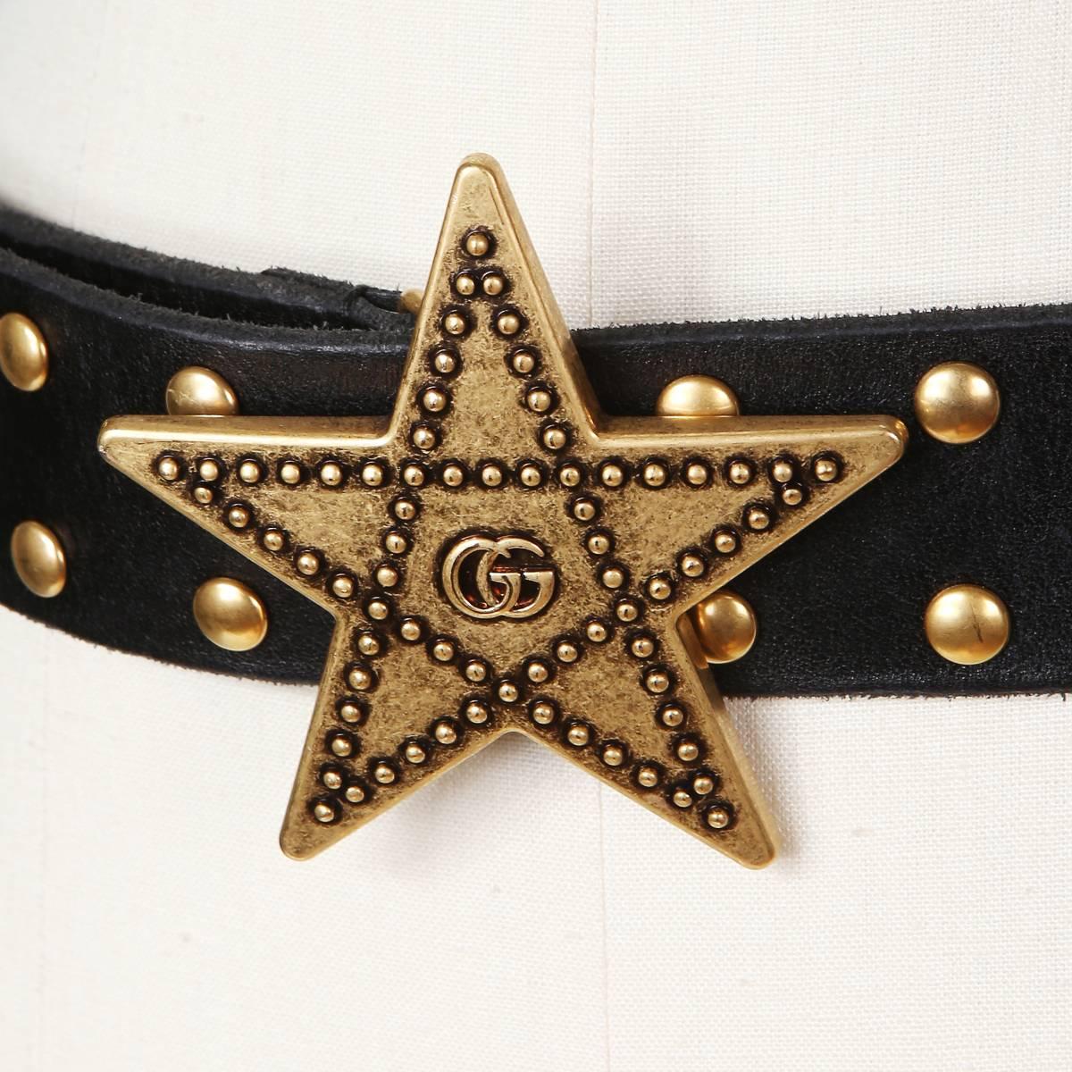 Gucci black leather belt.  Antique gold dome studs and star shaped belt buckle with GG logo.  

Belt size 80
Adjustable 30-32