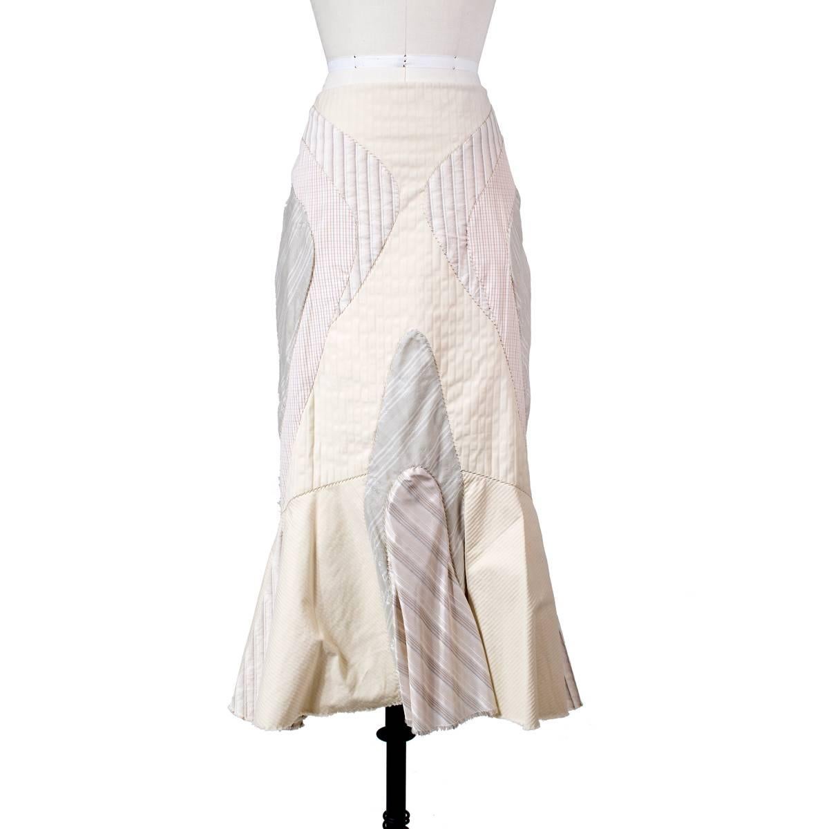 This is a skirt by Alexander McQueen from the S/S 2004 RTW collection.  It features a patchwork design of different patterns using pastel colors.  It has a mermaid shape and side zipper closure.  100% cotton outer with satin lining.  

Size 38
28