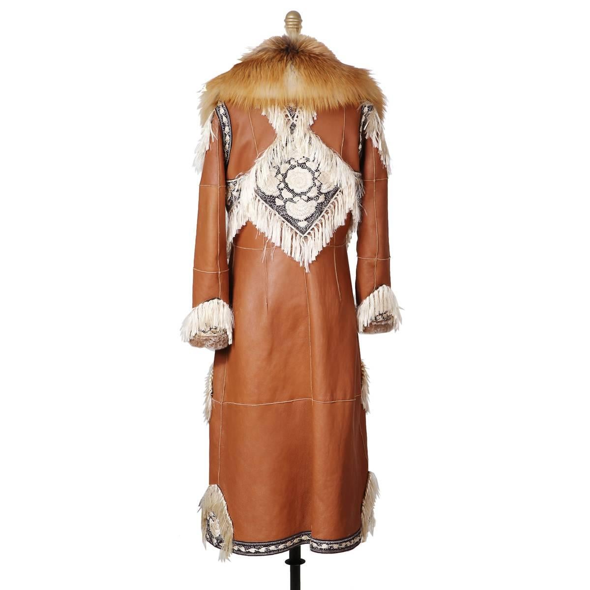 This is a coat from Alexander McQueen for the pre-fall 2016 collection.  Embroidery and fringe detail design with shearling lamb lining and a fox fur collar.  Hidden snap button closure in front.

Size 40
36