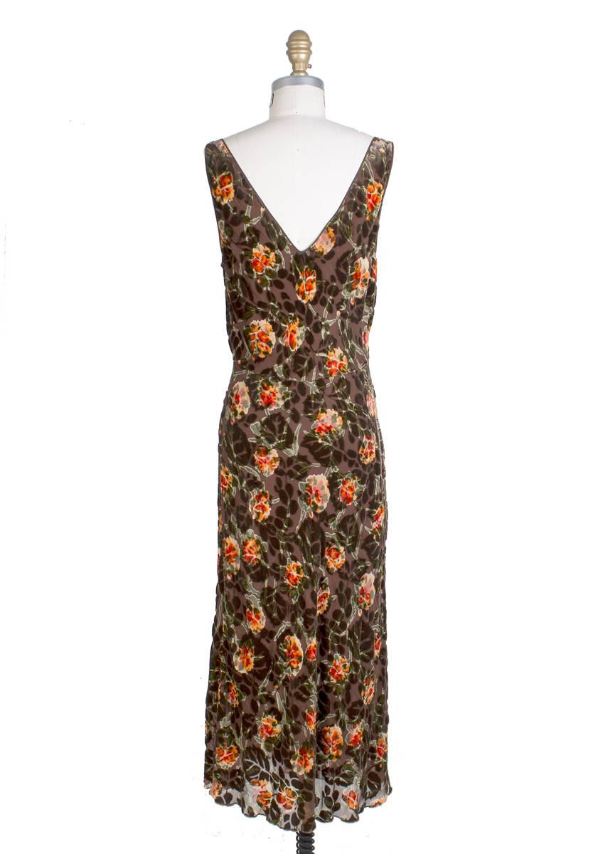 Dress and shawl set by John Galliano.  Features a warm toned floral pattern on a burned out velvet.  Matching shawl has fringe on each end.  Flared fit on skirt.

34
