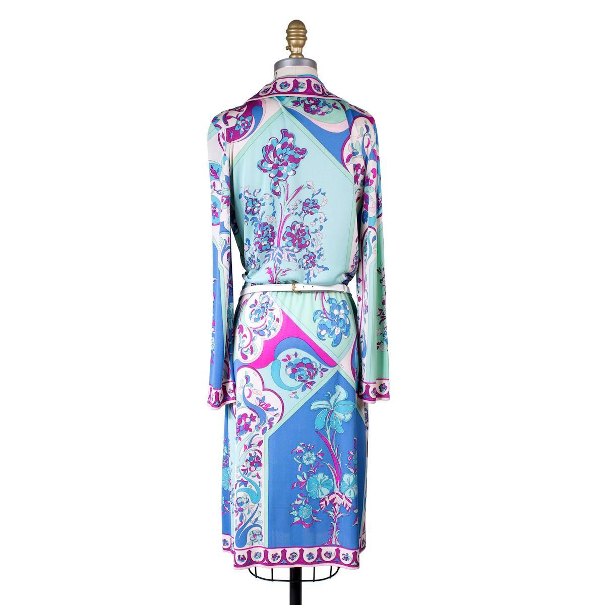 This is a vintage Pucci dress circa 1970s.  It features a signature Pucci print and includes a matching white leather belt to cinch the waist and button closures in front.