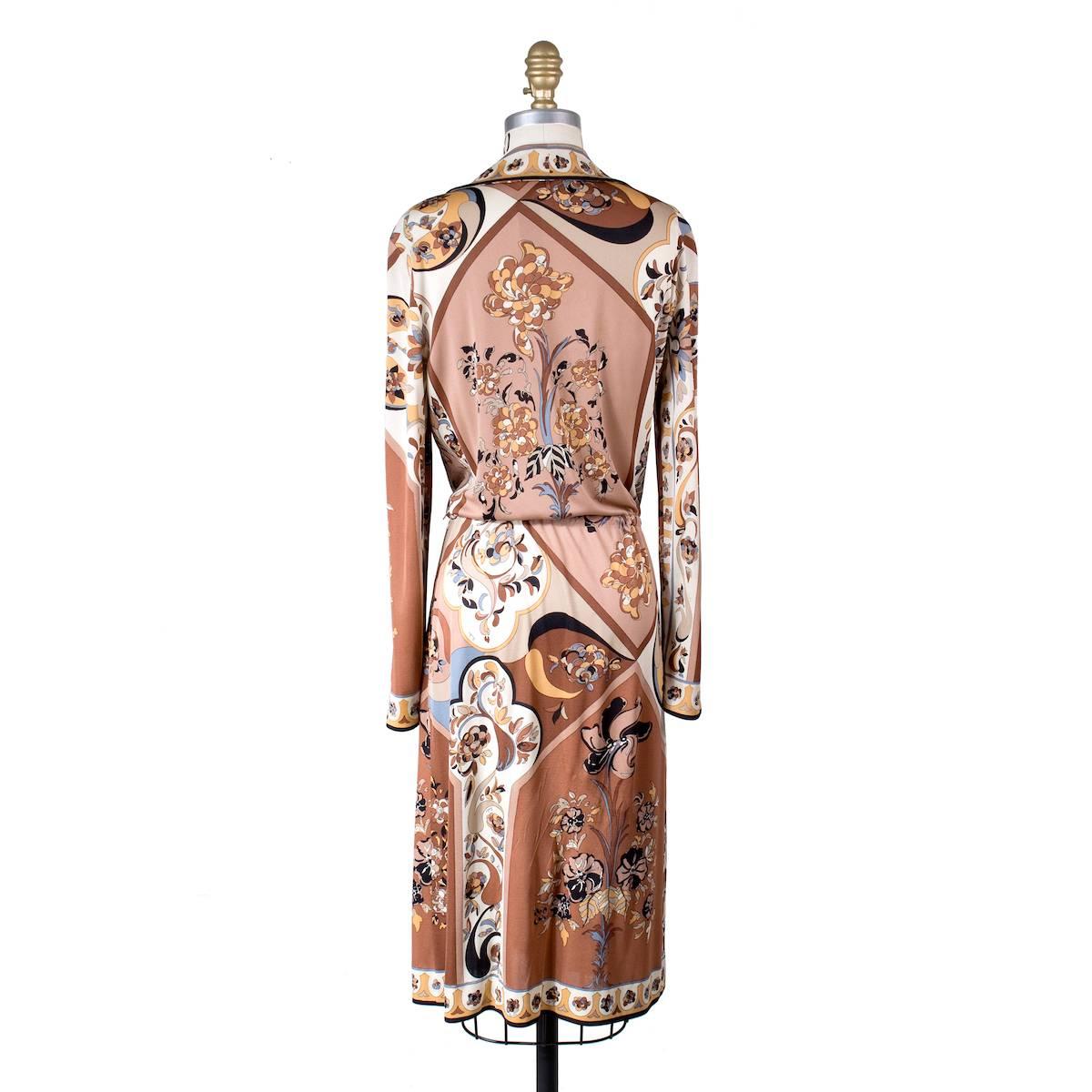 This is a vintage Pucci dress circa 1970s.  It features a signature Pucci print in brown and has a drawstring waist to cinch.  
